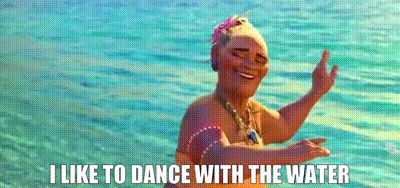 Animated clip of a figure dancing in turquoise ocean water, captioned 'I like to dance with the water'.